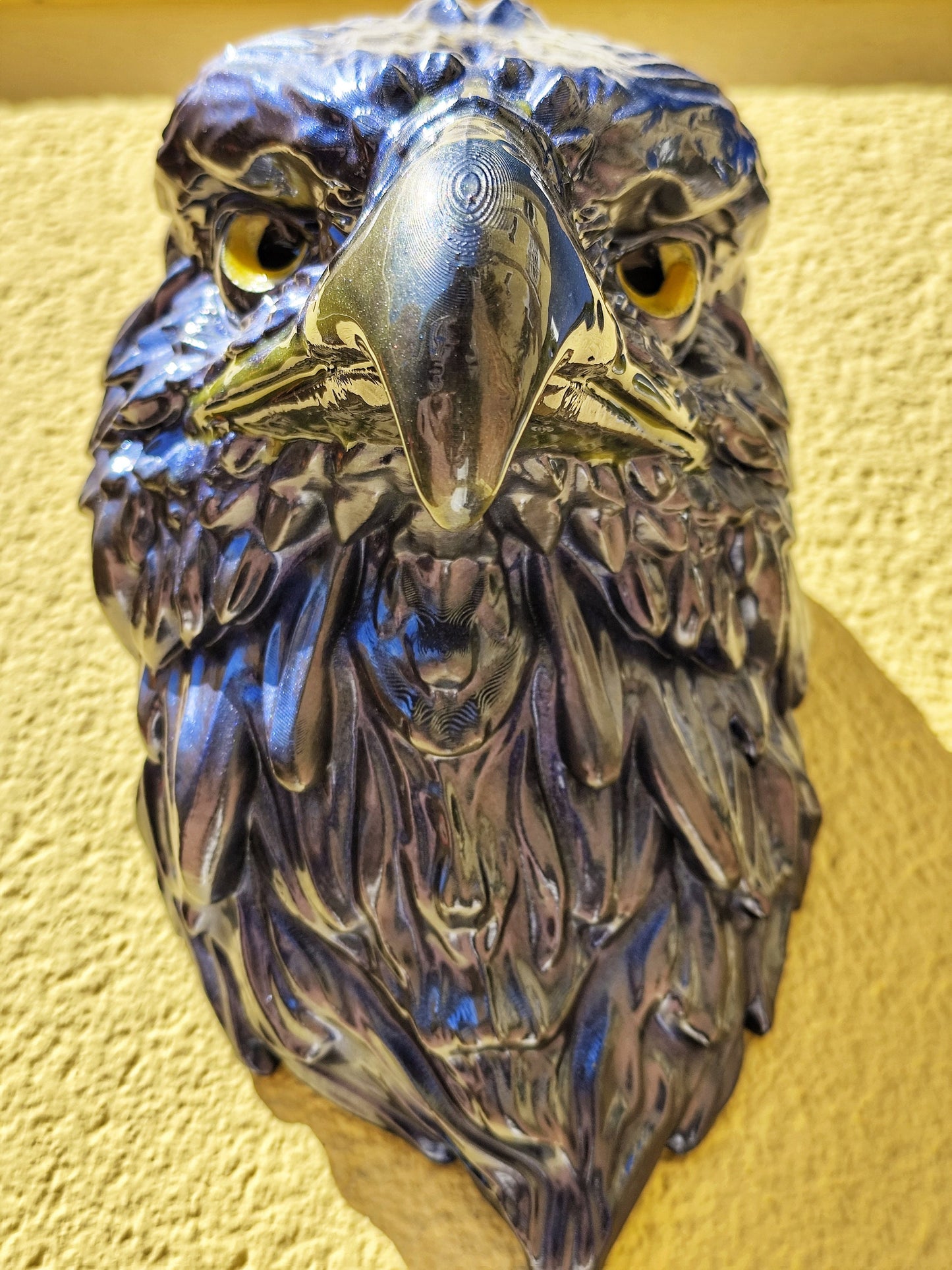 Shiny blue eagle head sculpture with intricate details